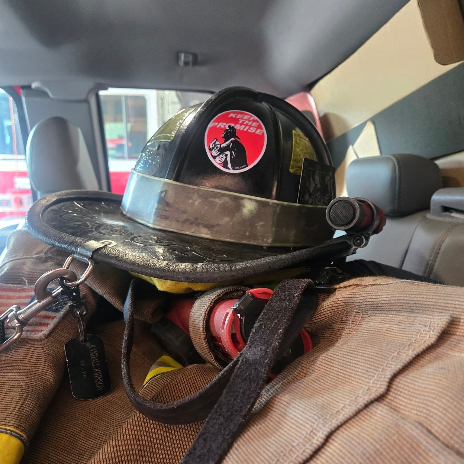 Firefighter helmet with a badge on a person sitting inside a vehicle