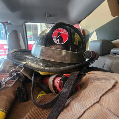 Firefighter helmet with a badge on a person sitting inside a vehicle